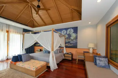 a bedroom with a canopy bed and a couch at Krabi Resort in Ao Nang Beach