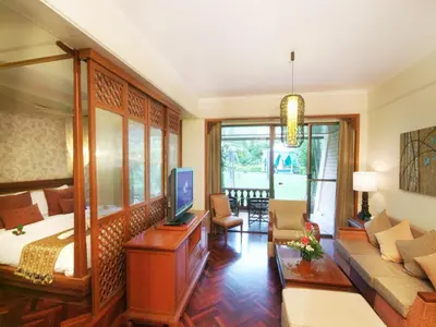 a living room with a bed and a couch and a tv at Krabi Resort in Ao Nang Beach