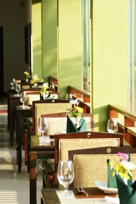 a row of tables and chairs in a restaurant at Palm Paradise, Aonang Resort in Ao Nang Beach