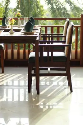 a wooden table and chair sitting on a porch at Palm Paradise, Aonang Resort in Ao Nang Beach