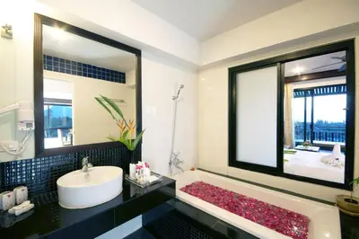 a bathroom with a sink and a bath tub at Palm Paradise, Aonang Resort in Ao Nang Beach