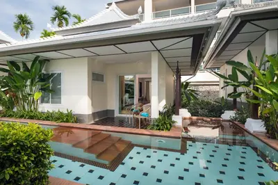 a villa with a swimming pool and a house at Anyavee Tubkaek Beach Resort in Tab Kaek Beach