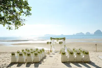 a row of chairs and a altar on the beach at Anyavee Tubkaek Beach Resort in Tab Kaek Beach
