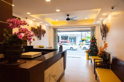 a restaurant with a counter with flowers on it at Q Victory Patong Hotel in Patong Beach