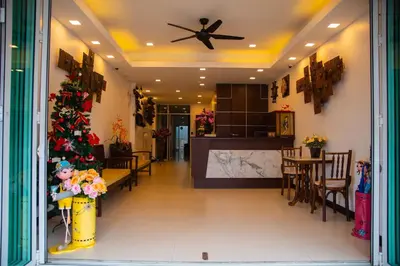 a living room with a christmas tree and a kitchen at Q Victory Patong Hotel in Patong Beach