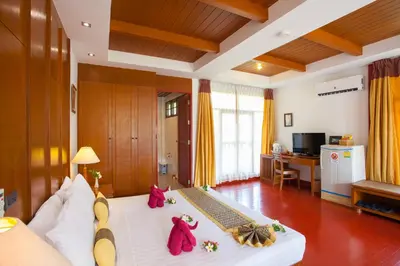 a room with a bed with stuffed animals on it at PP Erawan Palms Resort in Phi Phi Don