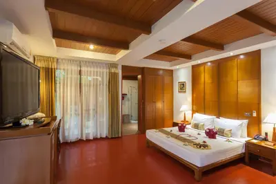 a bedroom with a large bed and a flat screen tv at PP Erawan Palms Resort in Phi Phi Don