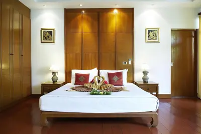 a bedroom with a large white bed and two lamps at PP Erawan Palms Resort in Phi Phi Don