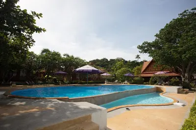 a swimming pool in a resort with umbrellas at PP Erawan Palms Resort in Phi Phi Don