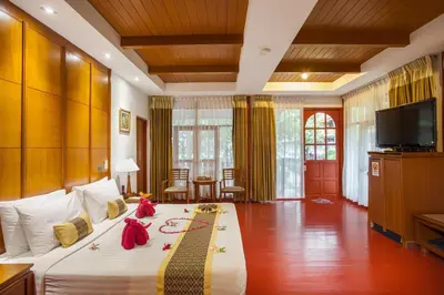 a bedroom with a large bed with a television on it at PP Erawan Palms Resort in Phi Phi Don