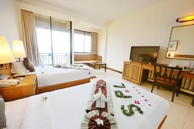 a hotel room with two beds and a flat screen tv at Supalai Scenic Bay Resort And Spa, SHA Extra Plus in Por Bay