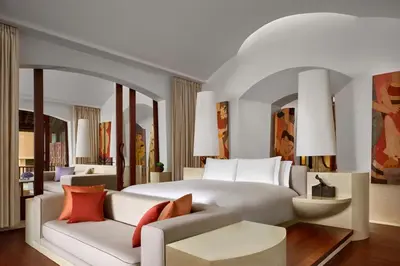 a bedroom with a large white bed and a couch at Phulay Bay, a Ritz-Carlton Reserve in Tab Kaek Beach