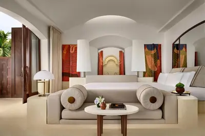 a bedroom with a large white bed and a table at Phulay Bay, a Ritz-Carlton Reserve in Tab Kaek Beach