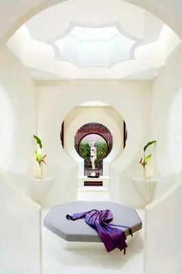 a room with a bed with a picture of a statue at Phulay Bay, a Ritz-Carlton Reserve in Tab Kaek Beach