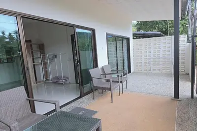a room with chairs and a table on a balcony at Nongthale Mountain View in Klong Muang Beach
