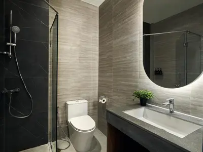 a bathroom with a toilet and a sink and a mirror at Panmanee Hotel-Newly Renovated in Phi Phi Don