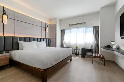 a hotel room with a bed and a desk at Panmanee Hotel-Newly Renovated in Phi Phi Don