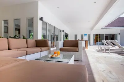 a living room with two couches and a table at Baan Lalle in Ao Nang Beach