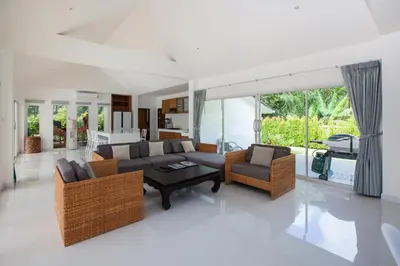 a living room with a couch and chairs and a table at Baan Lalle in Ao Nang Beach