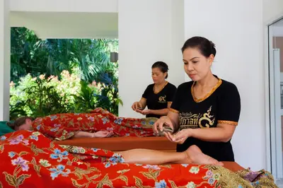 two women sitting on their beds in a bedroom at Baan Lalle in Ao Nang Beach