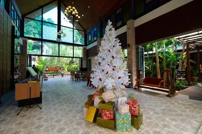 a christmas tree in a room with presents at HULA HULA RESORT l truly tropical and fun wellness in Ao Nang Beach