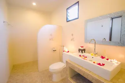 a bathroom with a tub and a toilet and a sink at Namphung Phuket Boutique Resort in Rawai Beach