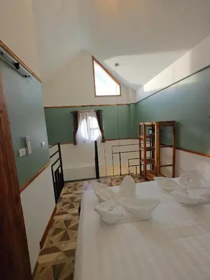 a room with a table with two white bowls on it at Namphung Phuket Boutique Resort in Rawai Beach