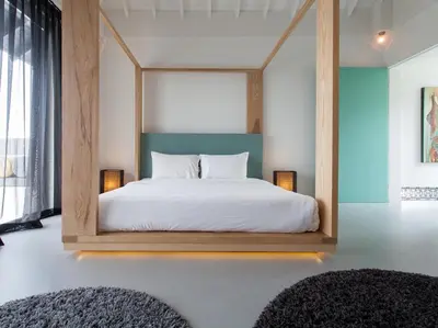 a bedroom with a bed with a wooden frame at Sammasan Seaview Villa by Elite Havens in Surin Beach
