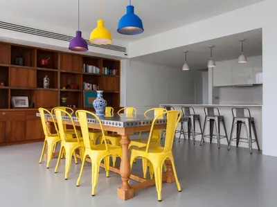 a dining room with a table and yellow chairs at Sammasan Seaview Villa by Elite Havens in Surin Beach