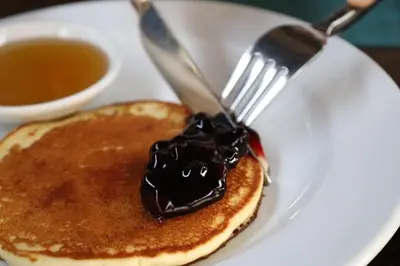 a plate with a fork and a pancake with chocolate icing at Sun Sea Sand Patong in Patong Beach