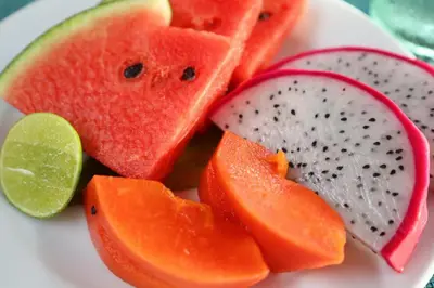 a plate of fruit with slices of watermelon and a lime at Sun Sea Sand Patong in Patong Beach