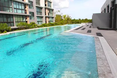 a swimming pool in the middle of a building at Connext Residence Phuket in Phuket Town