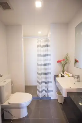 a bathroom with a toilet and a sink at Connext Residence Phuket in Phuket Town