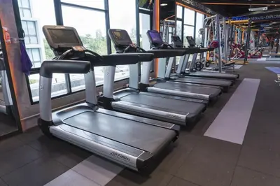 a row of treadmills in a gym at Connext Residence Phuket in Phuket Town