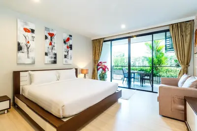 a bedroom with a bed and a balcony at Apartments at The Bliss Condo by Lofty in Patong Beach