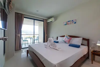 a bedroom with a bed with towels on it at Apartments at The Bliss Condo by Lofty in Patong Beach