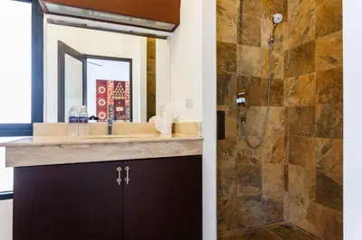a bathroom with a sink and a shower at Frangipani pool villa - garden, BBQ & maid in Nai Harn Beach