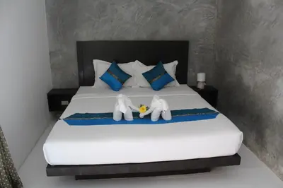 two stuffed elephants are sitting on a bed at B Happy Resort - SHA ExtraPlus in Kamala Beach