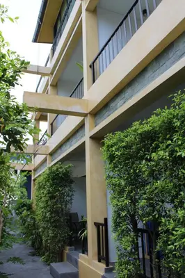 a building with green plants on the side of it at B Happy Resort - SHA ExtraPlus in Kamala Beach