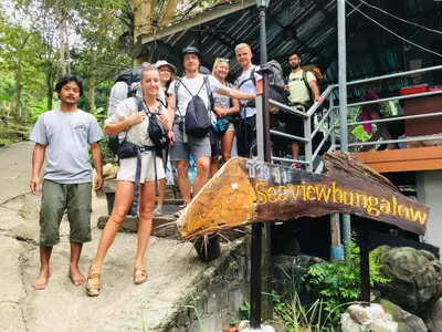 a group of people standing next to a sign at Sea View Bungalow in Phi Phi Don