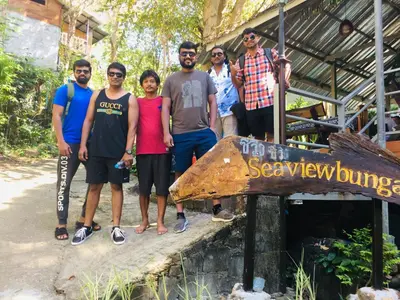 a group of people standing in front of a sign at Sea View Bungalow in Phi Phi Don