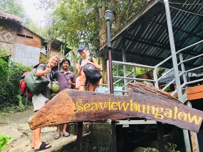 a group of people standing in front of a sign at Sea View Bungalow in Phi Phi Don