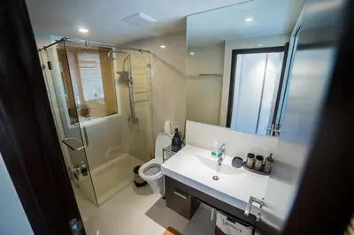 a bathroom with a shower and a sink and a toilet at The Title by Eeri in Rawai Beach