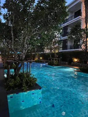 a swimming pool in front of a building at The Title by Eeri in Rawai Beach