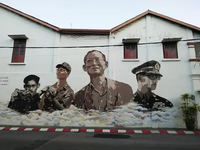 a mural of a group of men on the side of a building at In Phuket House in Phuket Town