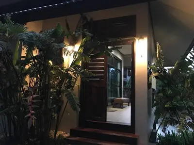a door to a house with plants in front of it at Lantala Residence in Natai Beach