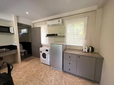 a small kitchen with a washing machine and a washer at Sakoo Valley Naithon Beach in Nai Thon Beach