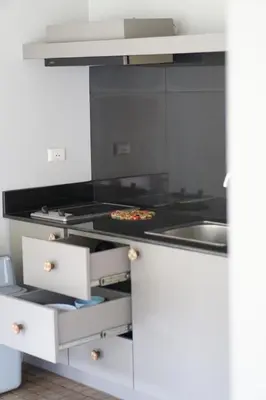 a kitchen with a stove with a pizza on it at Sakoo Valley Naithon Beach in Nai Thon Beach