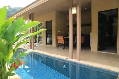 a house with a swimming pool in front of a house at Sakoo Valley Naithon Beach in Nai Thon Beach