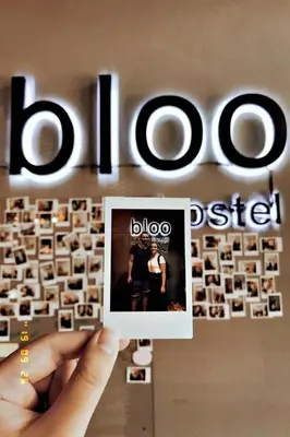 a person holding up a picture of a photo on a keyboard at Bloo Hostel in Phuket Town